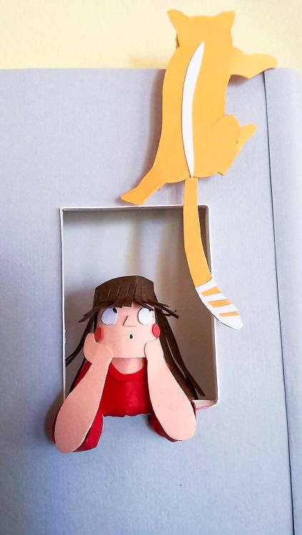 Paper art - Little girl frightened because her cat gets out of the house and climbs up to the roof. Diorama detail.