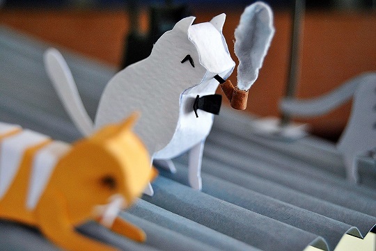 Paper art - Cat in bow tie smokes pipe while reveling in the music coming out of the Swing club. Diorama detail.