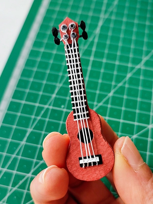 Paper art - Detail from diorama. Paper guitar. Miniature.