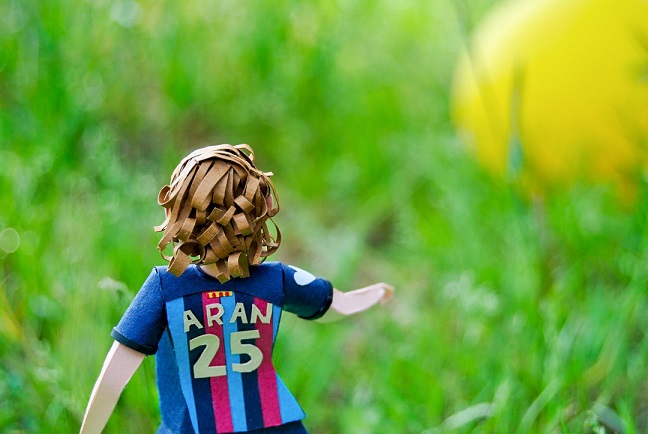 Paper art - Rear view of the miniature sculpture. Football / soccer player.