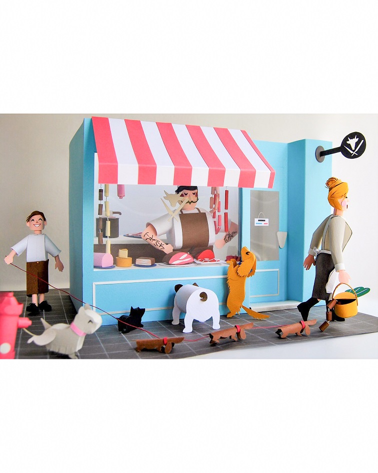 Paper art - General view of diorama. Butcher shop with dogs outside. Miniature.