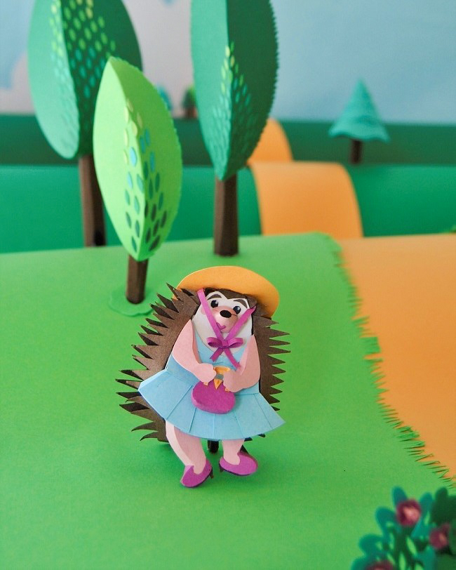 Paper Art - Cute hedgehog walking by the forest path. Paper diorama fragment.