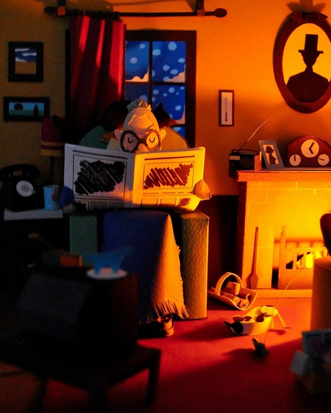 Arte con Papel - Abuela leyendo las noticias junto a la chimenea, de la miniatura de papel "Hogar, Dulce Hogar".