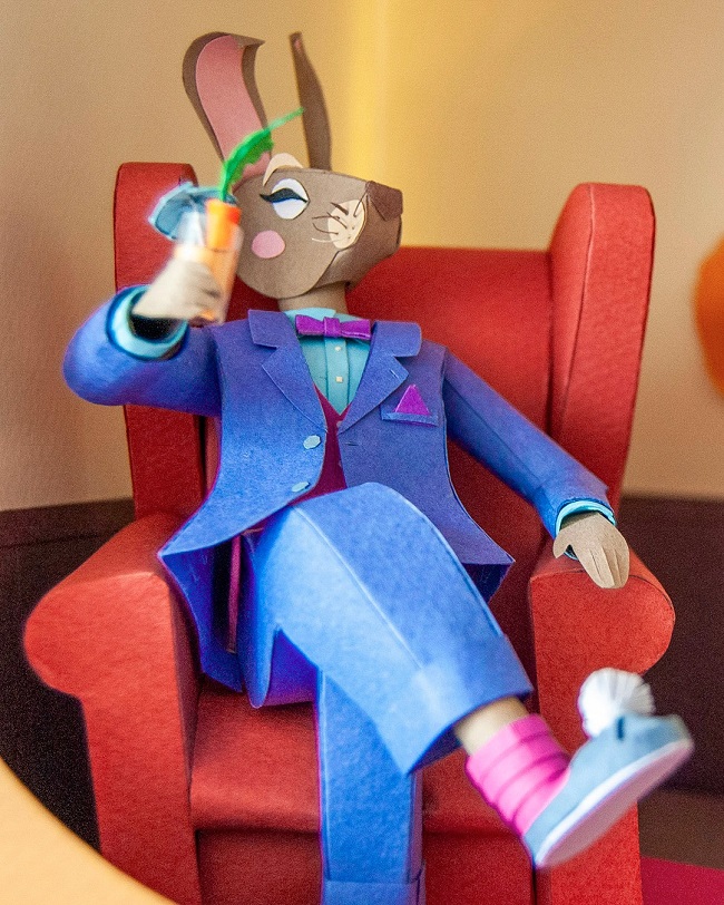 Paper Art - The hare enjoys a cocktail while sitting in his armchair. Paper sculpture.