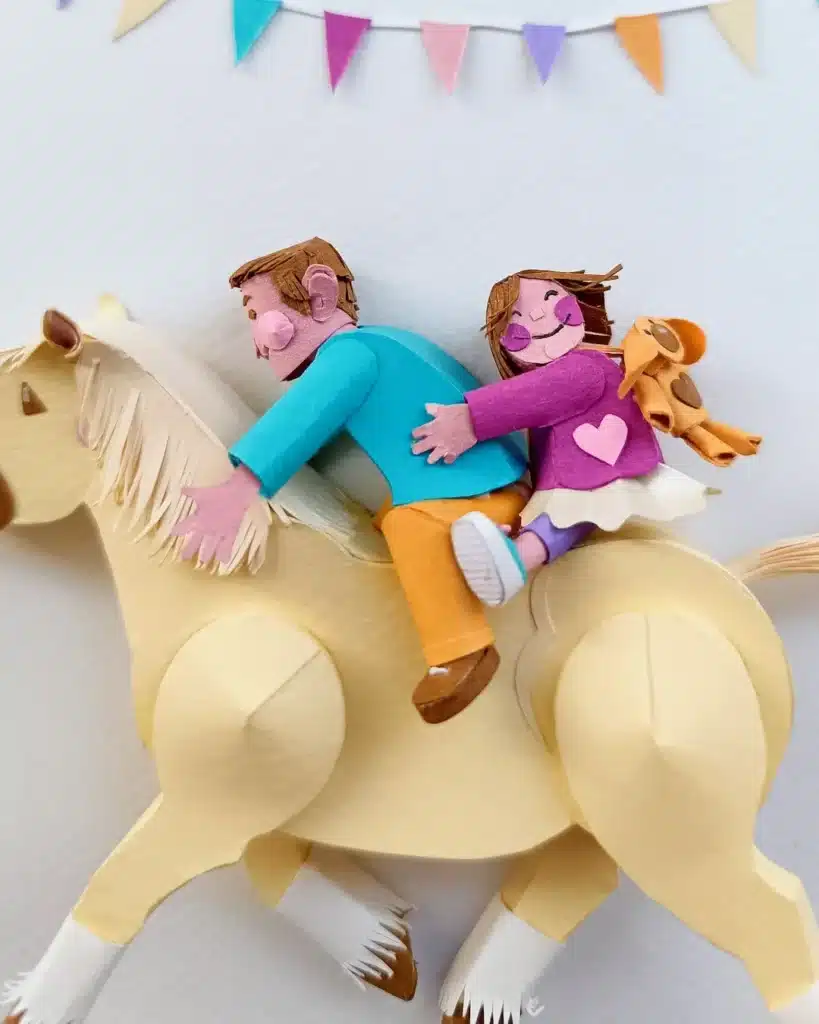 Paper Art - Two smiling siblings on a horse. Detail. Paper miniatures.